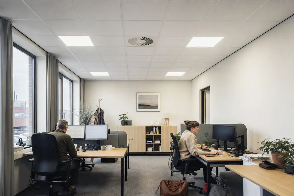 Kantoor met een akoestisch systeemplafond van witte tegels van 60 bij 60 centimeter